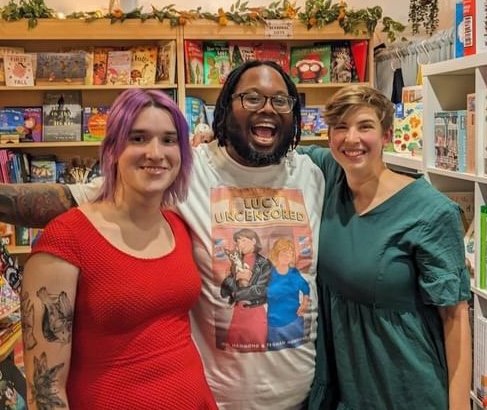 Mel and Teghan with Charles, wearing a Lucy, Uncensored t-shirt